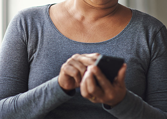 Close up image of woman using cell phone