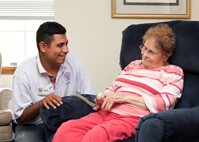 Image of technician helping elderly woman